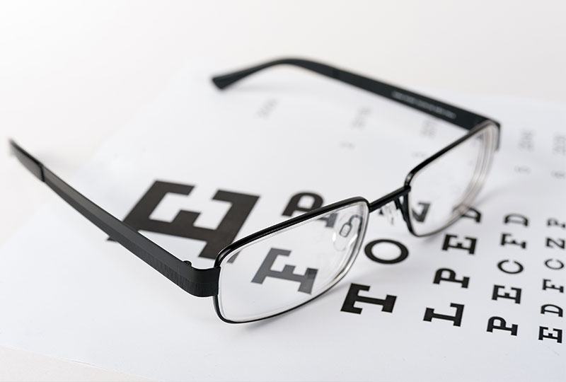 A woman sitting at a desk in an office, working on a computer.